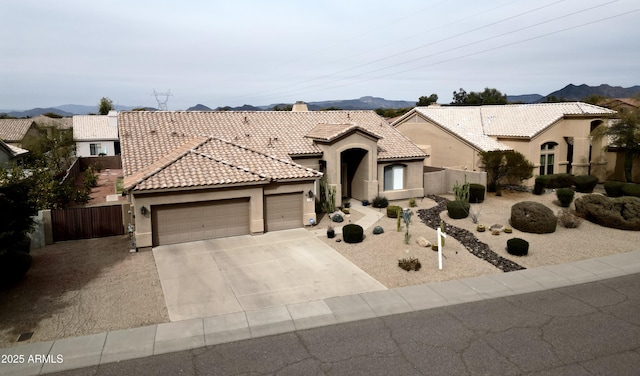 mediterranean / spanish-style house featuring a garage and a mountain view