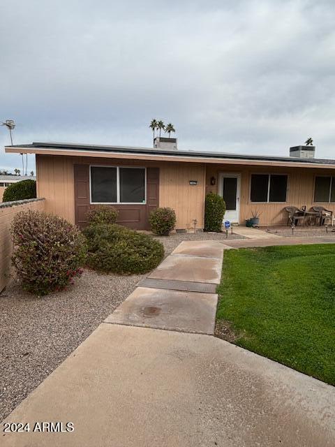 view of front of property with a patio and a front yard