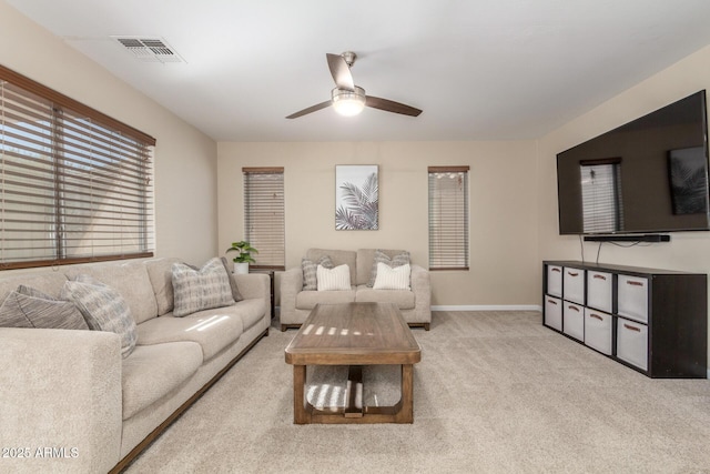 carpeted living room featuring ceiling fan