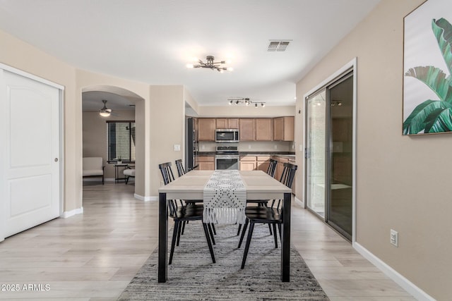 dining area with ceiling fan and light hardwood / wood-style floors