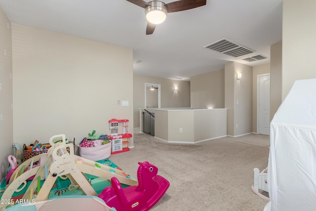 recreation room with ceiling fan and light colored carpet