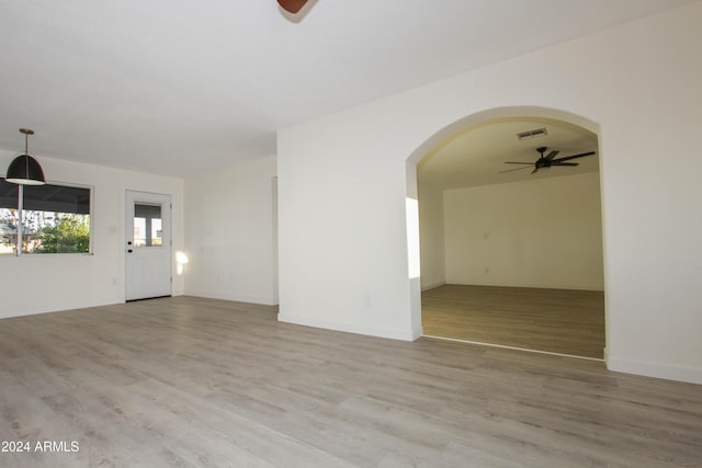 spare room featuring ceiling fan and light hardwood / wood-style floors