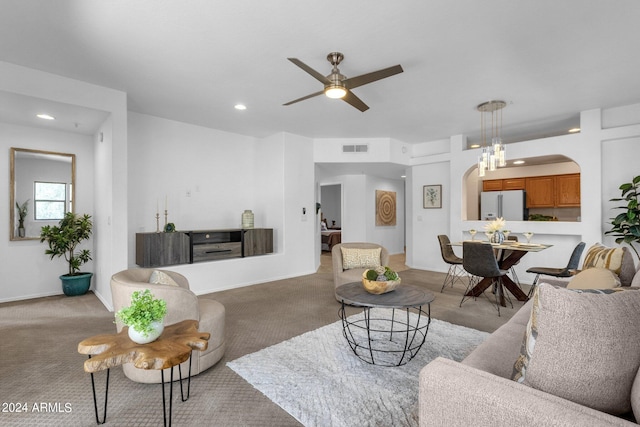 living room with ceiling fan and light colored carpet