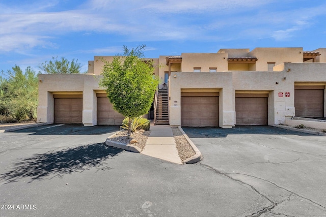 adobe home featuring a garage