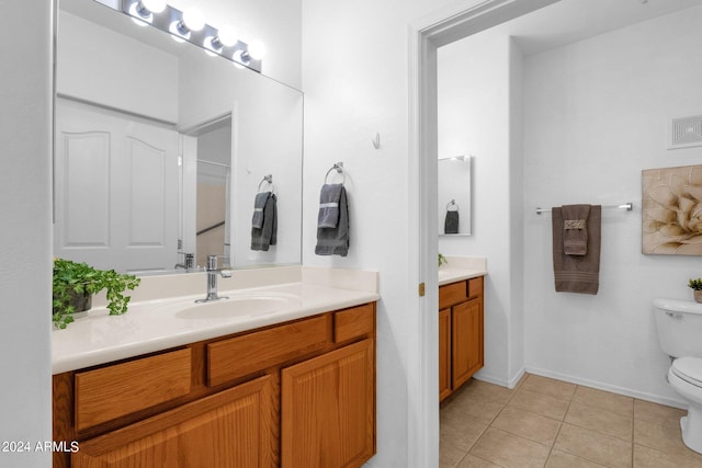 bathroom featuring tile patterned flooring, vanity, and toilet