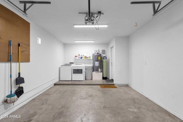 garage featuring washing machine and dryer and electric water heater