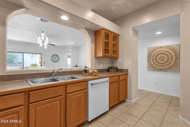 kitchen featuring hanging light fixtures, light tile patterned flooring, dishwasher, sink, and a notable chandelier