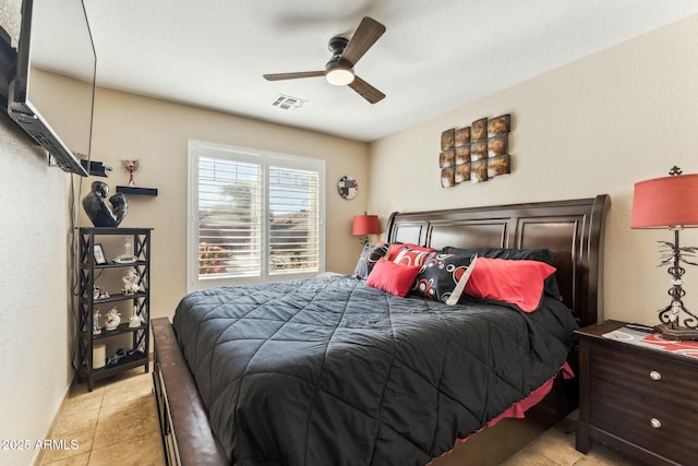 tiled bedroom featuring ceiling fan