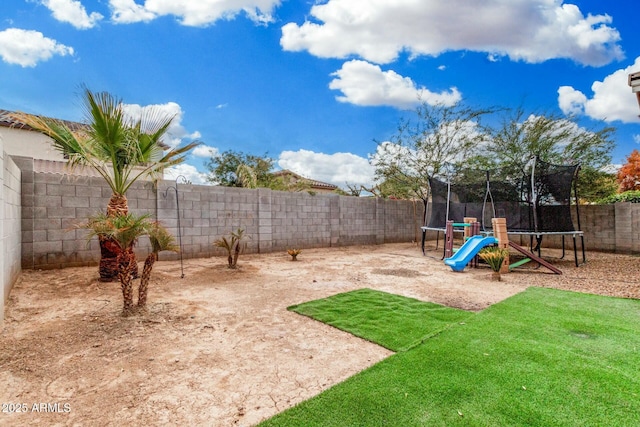 view of yard featuring a trampoline and a playground