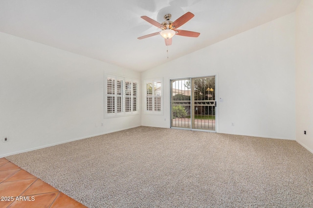 carpeted spare room with vaulted ceiling and ceiling fan