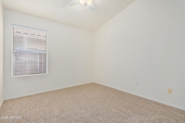 spare room featuring vaulted ceiling, ceiling fan, and carpet flooring