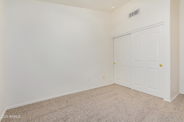 unfurnished room featuring light colored carpet