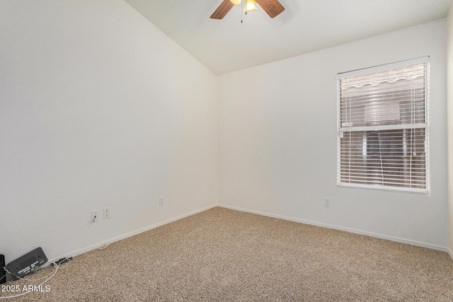 carpeted spare room featuring ceiling fan and lofted ceiling