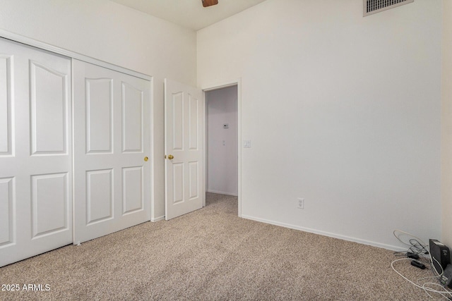 unfurnished bedroom featuring carpet flooring and a closet