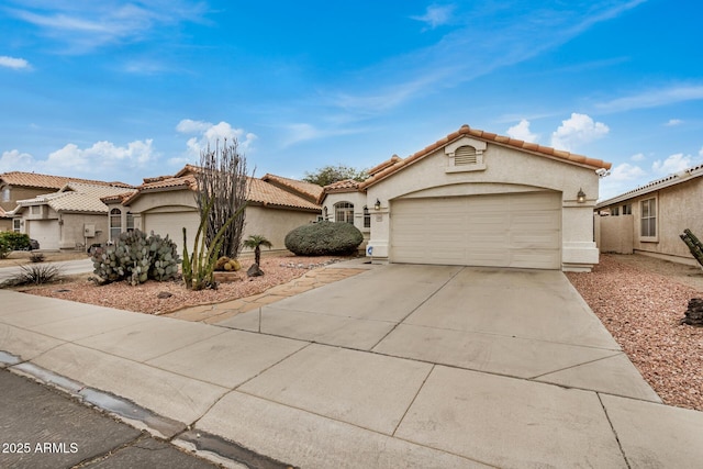 mediterranean / spanish-style home with a garage