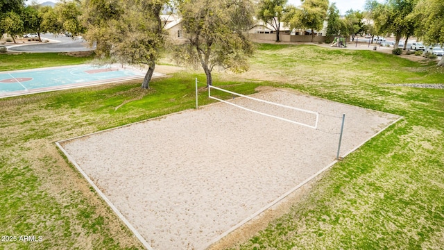 surrounding community featuring basketball court, a lawn, and volleyball court