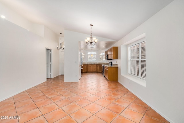 kitchen featuring pendant lighting, light tile patterned floors, stainless steel fridge, vaulted ceiling, and a chandelier