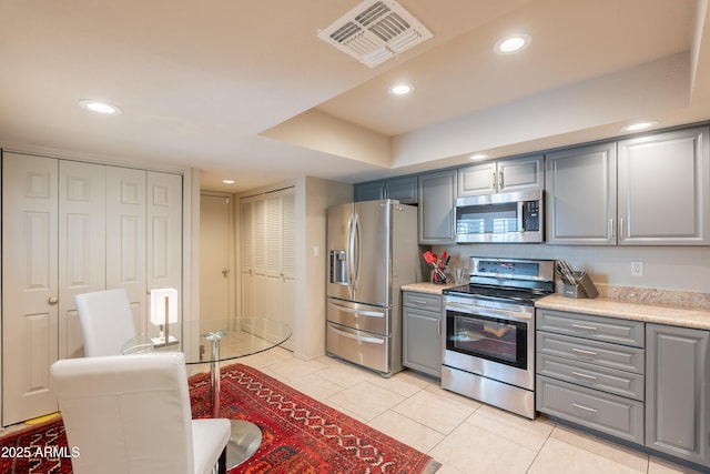 2413 E Rancho Dr, Phoenix, AZ 85016 - kitchen featuring stainless steel appliances, gray cabinetry, light tile patterned flooring, and recessed lighting