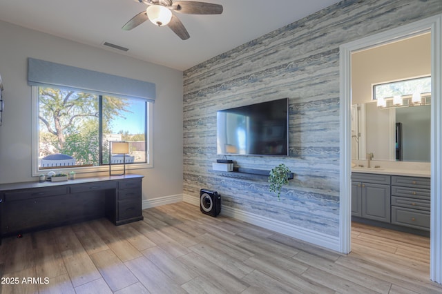 office with sink, ceiling fan, and light wood-type flooring