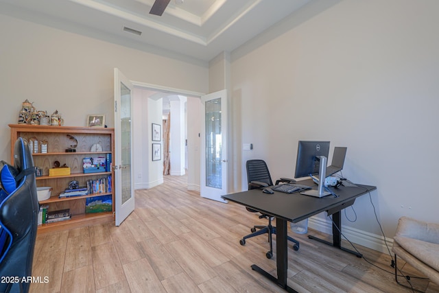 home office with ceiling fan, french doors, and light wood-type flooring