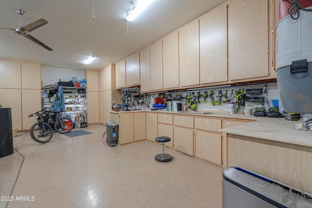 interior space with ceiling fan and light brown cabinetry