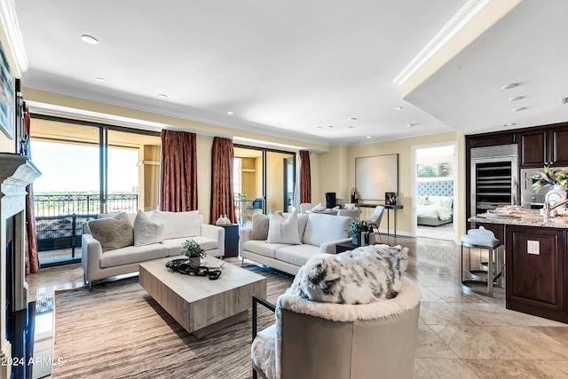 living room featuring a wealth of natural light, ornamental molding, and a premium fireplace