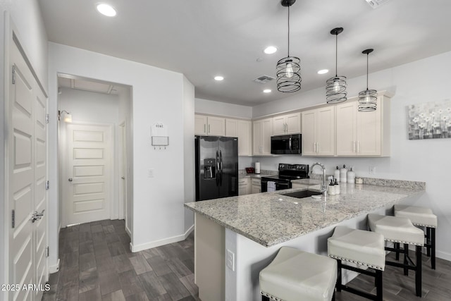 kitchen with pendant lighting, sink, stainless steel refrigerator with ice dispenser, black electric range, and kitchen peninsula