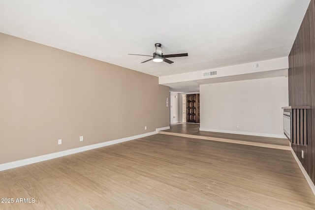 5526 N 77th Way, Scottsdale, AZ 85250 - spare room featuring a ceiling fan, light wood-type flooring, and baseboards