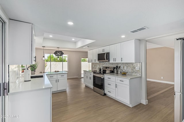5526 N 77th Way, Scottsdale, AZ 85250 - kitchen with appliances with stainless steel finishes, baseboards, a sink, light wood-style flooring, and tasteful backsplash