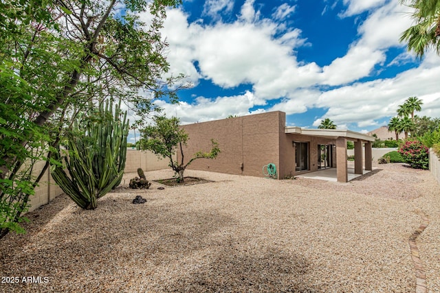 5526 N 77th Way, Scottsdale, AZ 85250 - rear view of property with stucco siding, a patio, and a fenced backyard