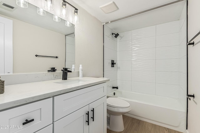 5526 N 77th Way, Scottsdale, AZ 85250 - bathroom featuring vanity, toilet, wood finished floors, and washtub / shower combination