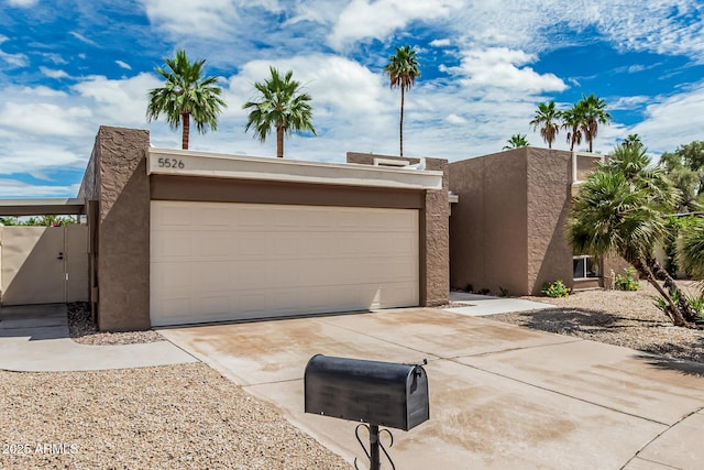 5526 N 77th Way, Scottsdale, AZ 85250 - view of front of property featuring driveway, stucco siding, and a garage