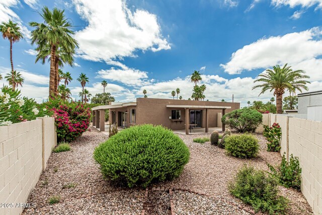 5526 N 77th Way, Scottsdale, AZ 85250 - rear view of house featuring stucco siding, a fenced backyard, and a patio area