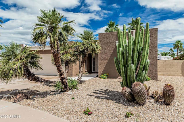 5526 N 77th Way, Scottsdale, AZ 85250 - view of front of property with a garage, driveway, and stucco siding