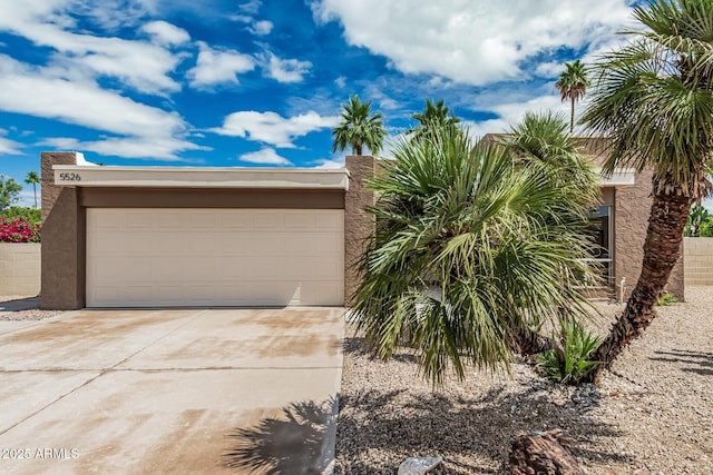 5526 N 77th Way, Scottsdale, AZ 85250 - view of front facade with concrete driveway, stucco siding, and an attached garage