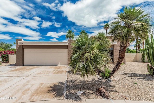 5526 N 77th Way, Scottsdale, AZ 85250 - view of front of home featuring concrete driveway, stucco siding, and a garage