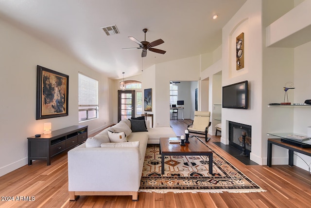 living room featuring ceiling fan, wood-type flooring, lofted ceiling, and french doors