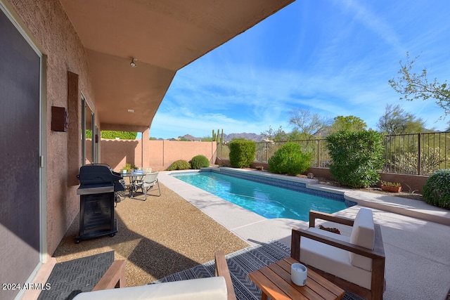 view of swimming pool with area for grilling and a patio