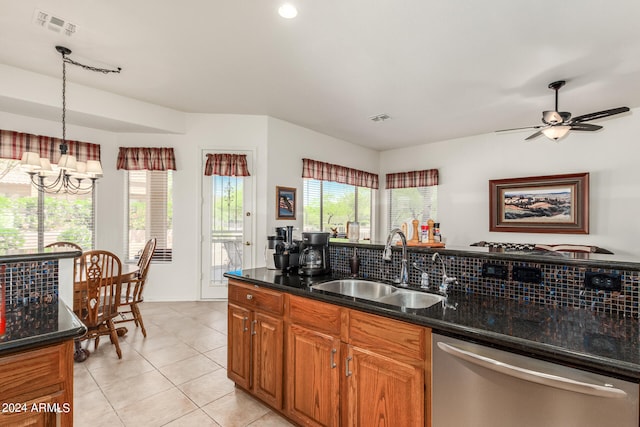 kitchen with light tile floors, sink, backsplash, stainless steel dishwasher, and dark stone countertops