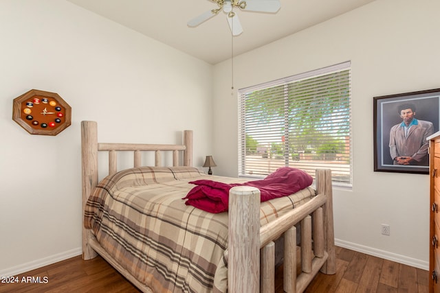 bedroom with dark hardwood / wood-style flooring and ceiling fan