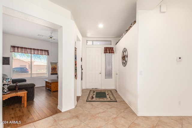 tiled foyer featuring ceiling fan