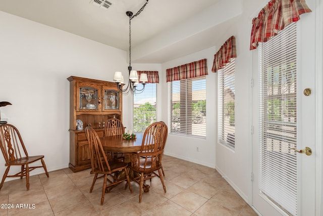 dining room featuring a notable chandelier and light tile floors