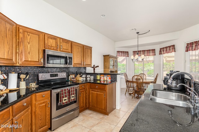 kitchen with backsplash, a chandelier, appliances with stainless steel finishes, light tile floors, and sink