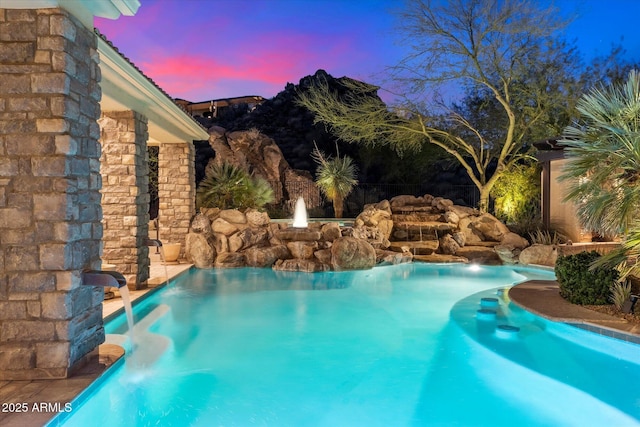 view of pool at dusk