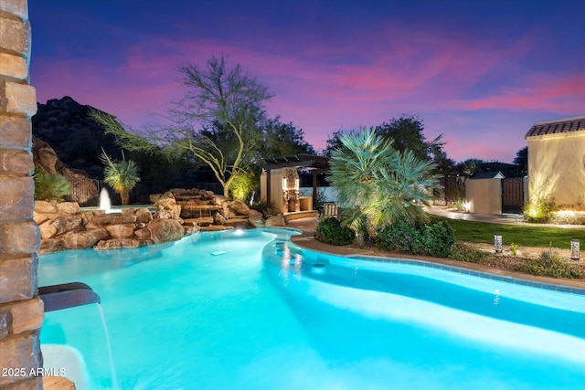 view of pool at dusk