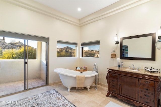 bathroom featuring vanity and a bath