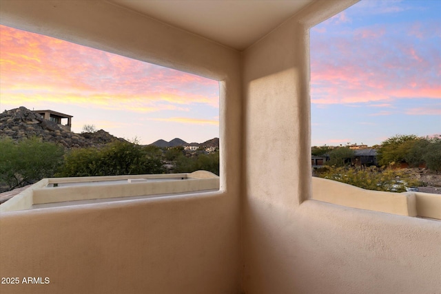 view of balcony at dusk