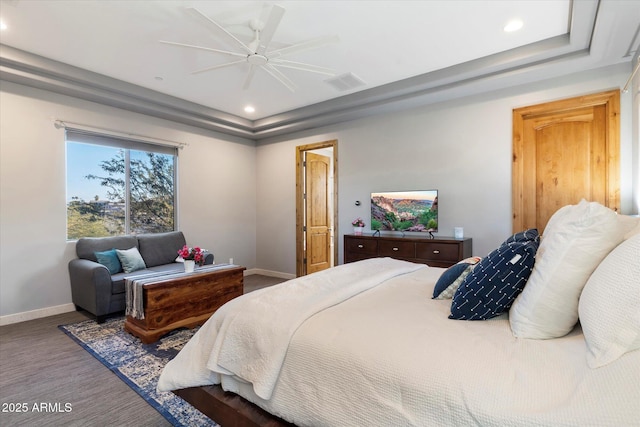 bedroom featuring ceiling fan and a raised ceiling