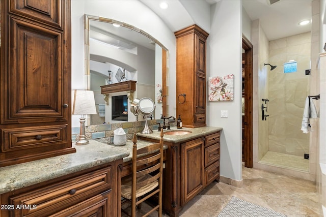 bathroom featuring vanity and a shower with door