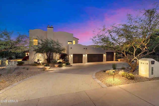 adobe home featuring a garage